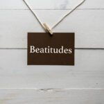 The word "Beatitudes" written in white letters on a black background.